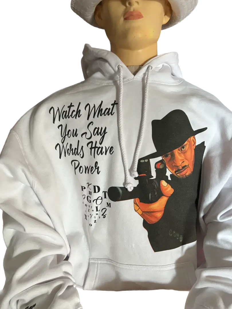 A manikin wearing a white hoodie with a person holding a gun